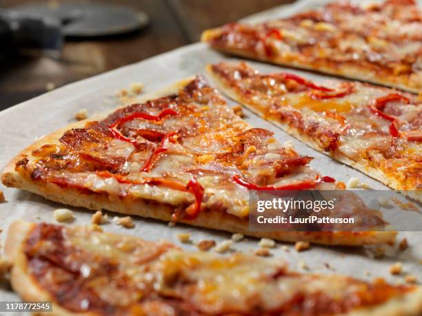 pepperoni flat bread pizza with red peppers - rectangle pizza stock pictures, royalty-free photos & images