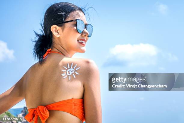 young woman with sun cream shape on shoulder, sun protection sun cream. - rash stock pictures, royalty-free photos & images
