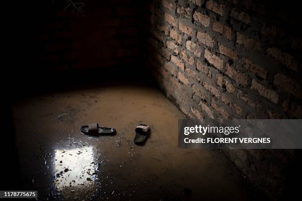 Pair of shoess float in what was once the living room of a house, flooded by water, in Bangui, on October 25, 2019. Decadal floods are commonplace on...