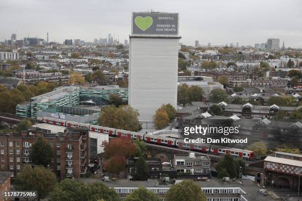 General view of what remains of Grenfell Tower covered with hoardings following a severe fire in June 2017 on October 29, 2019 in London, England....