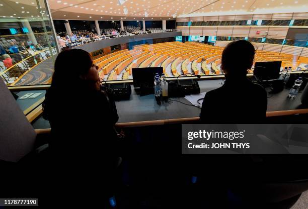 People sit in a booth during an open day on the profession of translator for the European parliament on September 29 2019 at the EU headquarter in...