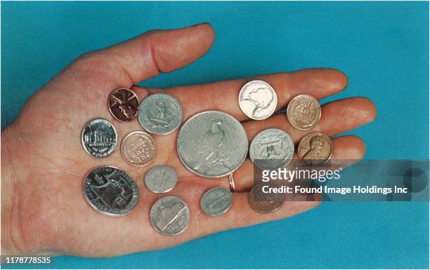 Hand with a selection of American coins.