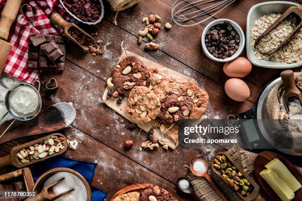 chocolate and nuts cookie making on rustic table with digital food weight scale.  christmas themes. - almond cookies stock pictures, royalty-free photos & images