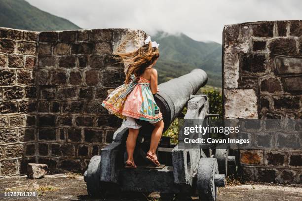 young girl plays in old fortress on a st kitts island cruise port stop - saint kitts and nevis stock pictures, royalty-free photos & images