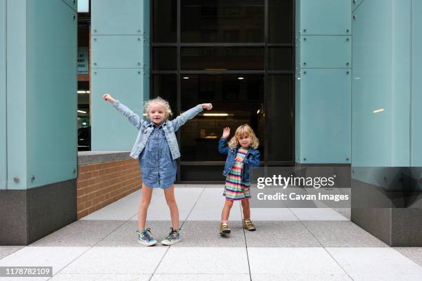 girls playing outside of apartment building - kids fashion show stock pictures, royalty-free photos & images