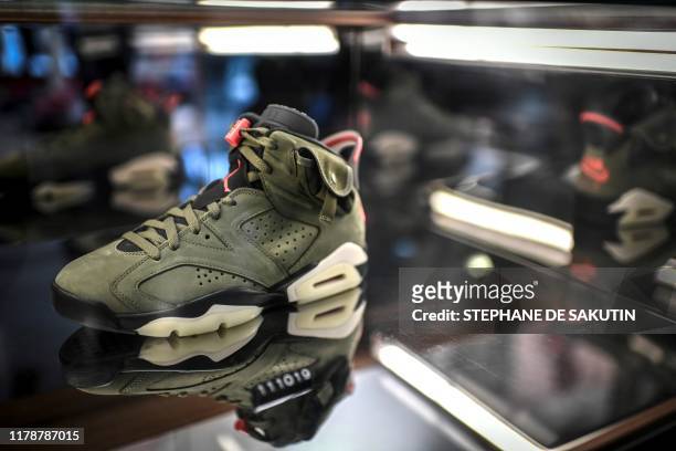 Limited edition of the Travis Scott x Air Jordan 6 sneaker is displayed in a shop as part of the 'raffles' on October 8, 2019 in Paris.
