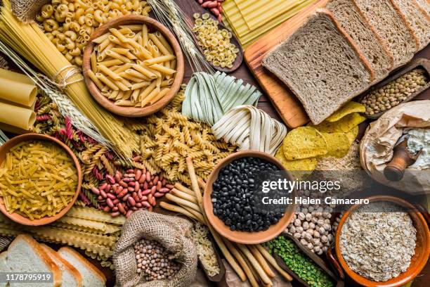 wholegrain and dietary fiber food on rustic wooden background - wholegrain foto e immagini stock