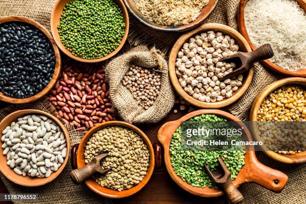 top view of leguminous seeds on rustic wood table - bean stock-fotos und bilder