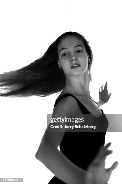 In a black leotard, American ballerina Suzanne Farrell spins against a white background, New York, New York, January 31, 1964.