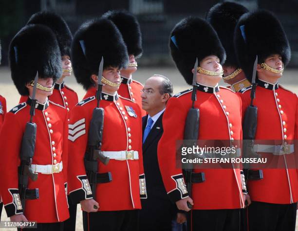 Mexican President Felipe Calderón inspects guards on Horseguards Parade on the first day of his four-day state visit, in London, on March 30, 2009....