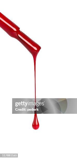 nail brush with red polish dripping on a white background - nail varnish stock pictures, royalty-free photos & images