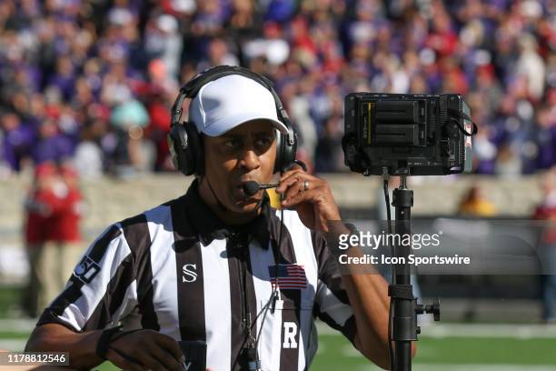 Referee Reggie Smith prepares for a video review of an on-side kick recovered by the Sooners with 1:45 left in the fourth quarter of a Big 12...