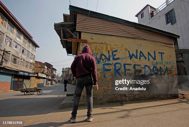 Kashmiri protester holds a stone as he is looking towards Indian policemen in Srinagar,Kashmir on October 29, 2019. Protest and clashes were reported...