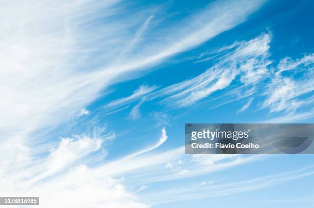 white clouds on blue sky flowing with the wind - 巻雲 ストックフォトと画像