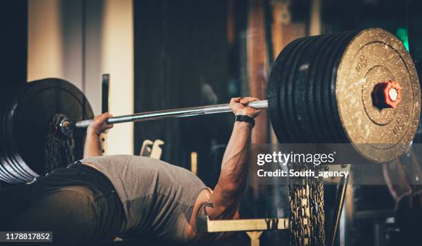 man weightlifter at the gym - weight bench stock pictures, royalty-free photos & images