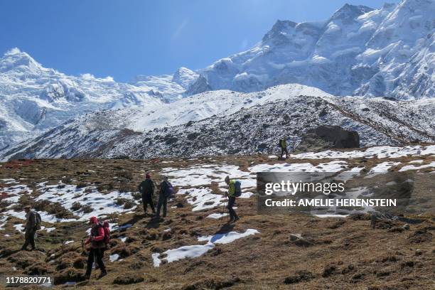 In this picture taken on October 13 foreign tourists and their guides trek down from Nanga Parbat base camp. - Such was the determination of Nepali...