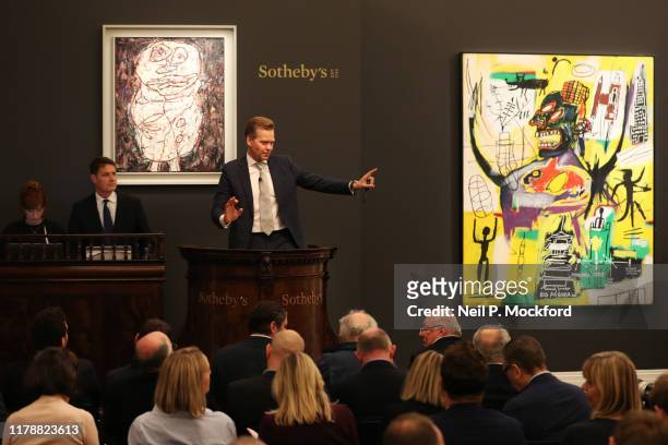 Sotheby’s European Chairman, Oliver Barker, brings the hammer down on Banksy’s record-breaking dystopian view of The House of Commons overrun with...