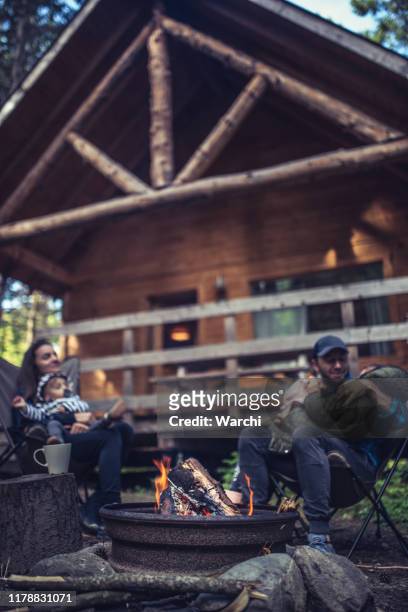 bonding moments by the camp fire - cottage family stock pictures, royalty-free photos & images