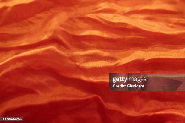 orange scarf rippled background - silk garment stock pictures, royalty-free photos & images