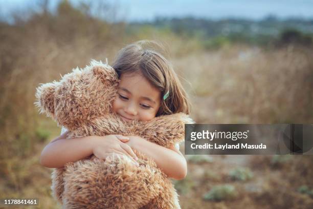 teddy bear hugs with happy 3 years girl - stuffed animal stock pictures, royalty-free photos & images