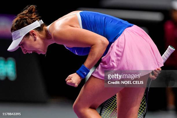 Belinda Bencic of Switzerland reacts during her women's singles match in the WTA Finals tennis tournament against Petra Kvitova of Czech Republic in...