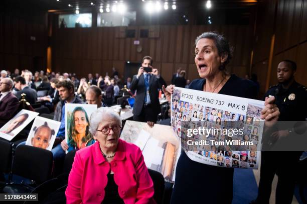 Nadia Milleron, whose daughter Samya Stumo, was killed in the crash of Ethiopian Airlines Flight 302, holds a sign of crash victims behind Dennis...
