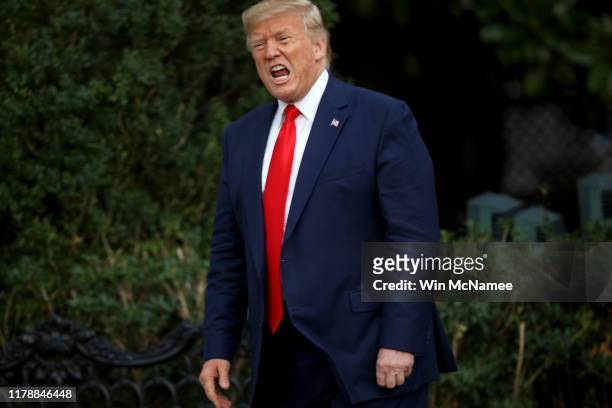 President Donald Trump shouts at members of the media as he returns to the White House on October 03, 2019 in Washington, DC. Trump traveled to...