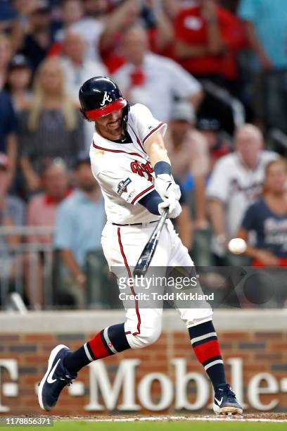 Dansby Swanson of the Atlanta Braves reaches first base on a fielders choice and an error as two runs score against the St. Louis Cardinals during...
