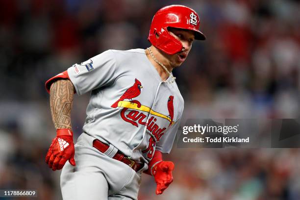 Kolten Wong of the St. Louis Cardinals hits a two-RBI double against the Atlanta Braves during the ninth inning in game one of the National League...