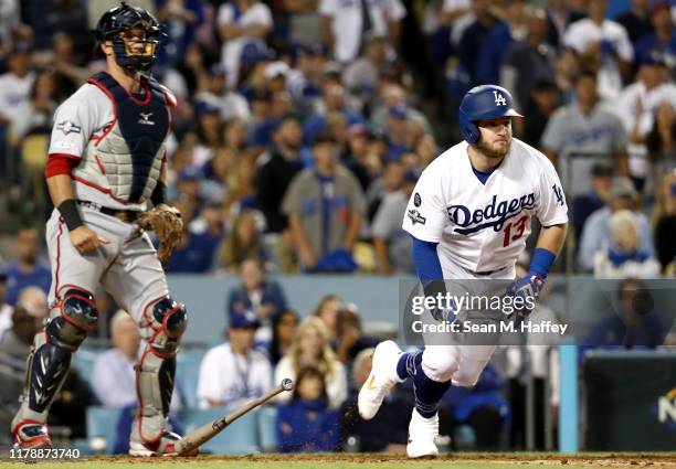 Max Muncy of the Los Angeles Dodgers hits an RBI single in the fifth inning of game one of the National League Division Series against the Washington...