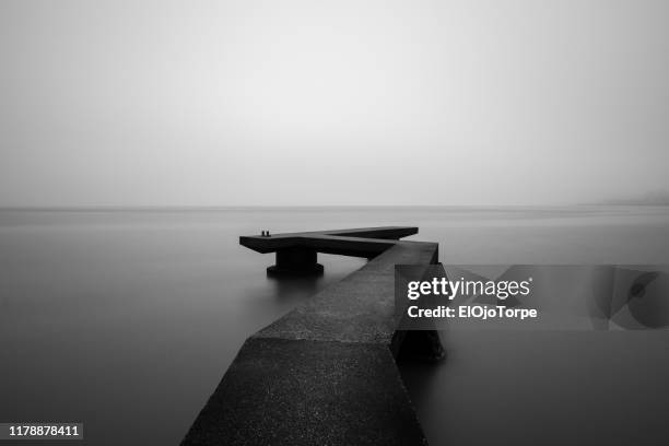 black and white image, pier over rio de la plata, no people in the image - uruguai - fotografias e filmes do acervo