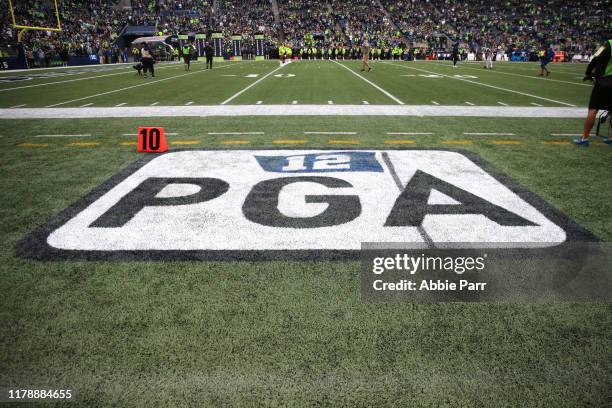 Logo of former Seattle Seahawks owner Paul Allen's initials is printed on the field after he was inducted into Century Link field's ring of honor...