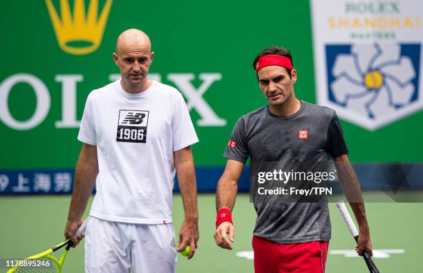 Roger Federer of Switzerland practices with his coach, Ivan Ljubicic at Qi Zhong Tennis Centre on October 04, 2019 before the start of the Rolex...