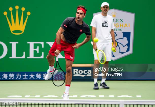 Roger Federer of Switzerland practices with his coach, Ivan Ljubicic at Qi Zhong Tennis Centre on October 04, 2019 before the start of the Rolex...