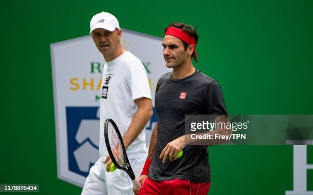 Roger Federer of Switzerland practices with his coach, Ivan Ljubicic at Qi Zhong Tennis Centre on October 04, 2019 before the start of the Rolex...