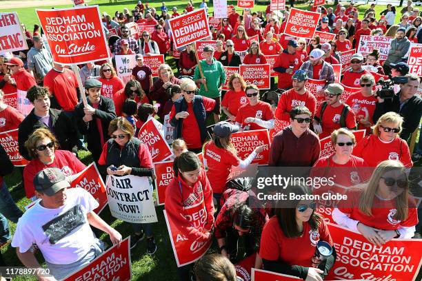 Hundreds of Dedham teachers and supporters rally at a baseball field across from the American Legion Hall on Eastern Avenue in Dedham, MA after going...