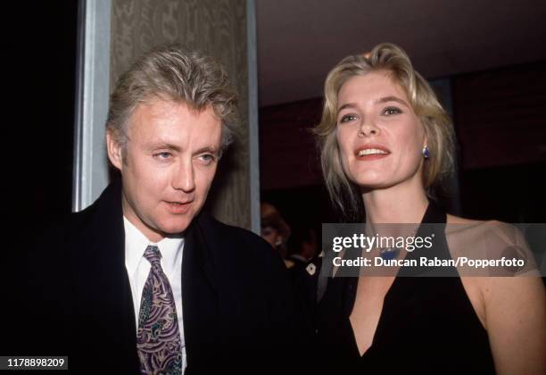 Queen drummer and vocalist Roger Taylor with his girlfriend supermodel Deborah Leng attending an event in London, circa 1990.