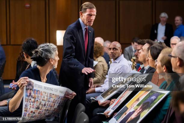 Sen. Richard Blumenthal, D-Conn., talks with family members of crash victims before the testimony of Dennis Muilenburg, CEO of Boeing, during the...