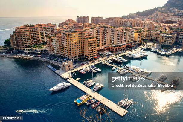 beautiful aerial view of the city and pier of monaco on a bright sunny day - monte carlo harbour stock pictures, royalty-free photos & images