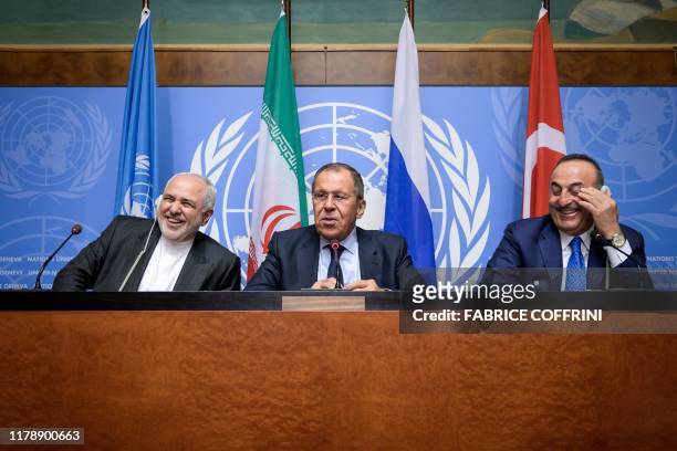 Iranian Foreign Minister Mohammad Javad Zarif, Russian Foreign Minister Sergei Lavrov and Turkish Foreign Minister Mevlut Cavusoglu react during a...