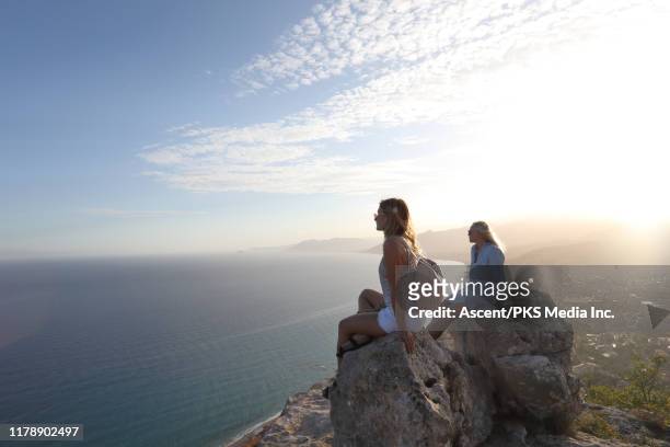 mother and daughter look off from rock summit - weekend activities stock pictures, royalty-free photos & images