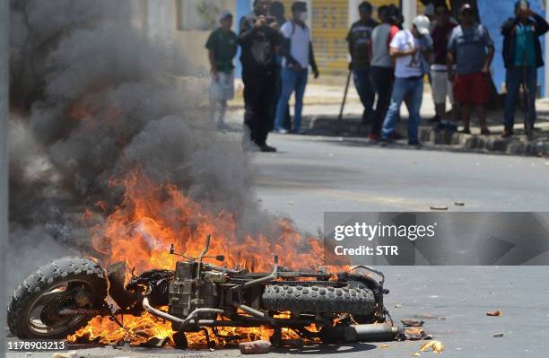 Motorbike set on fire by supporters of Bolivian President Evo Morales burns during clashes with supporters of defeated presidential candidate Carlos...