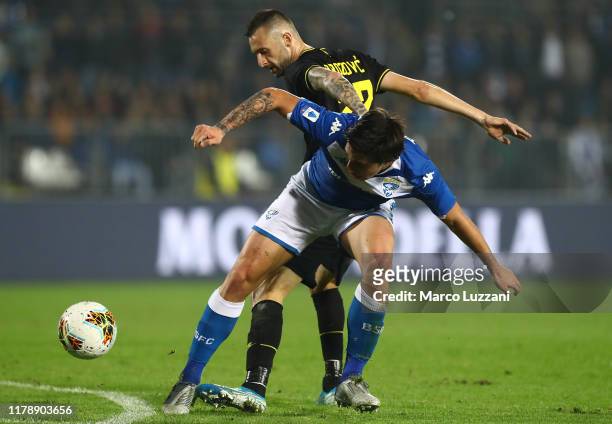 Sandro Tonali of Brescia Calcio competes for the ball with Marcelo Brozovic of FC Internazionale during the Serie A match between Brescia Calcio and...