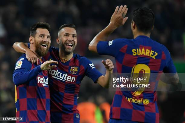 Barcelona's Argentine forward Lionel Messi celebrates his goal with Barcelona's Spanish defender Jordi Alba and Barcelona's Uruguayan forward Luis...