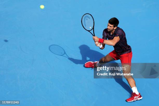 Novak Djokovic of Serbia returns a shot during his match against Lucas Pouille of France on day five of the Rakuten Open at the Ariake Coliseum on...