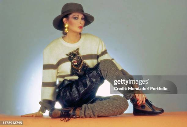 French-born Italian actress Edwige Fenech posing seated. 1983