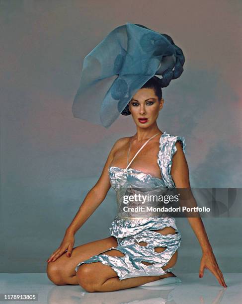 French-born Italian actress Edwige Fenech wearing a silver dress. 1987