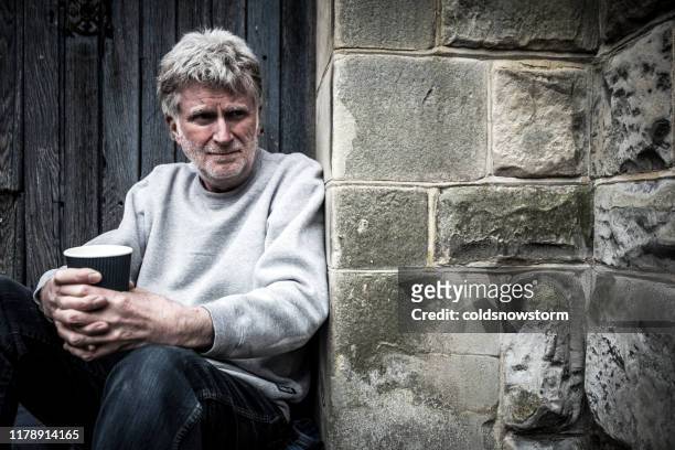 homeless senior man begging in doorway - homeless man stock pictures, royalty-free photos & images