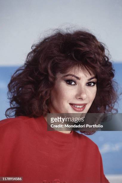 French-born Italian actress and presenter of the TV show Domenica In Edwige Fenech smiling. Italy, 1989