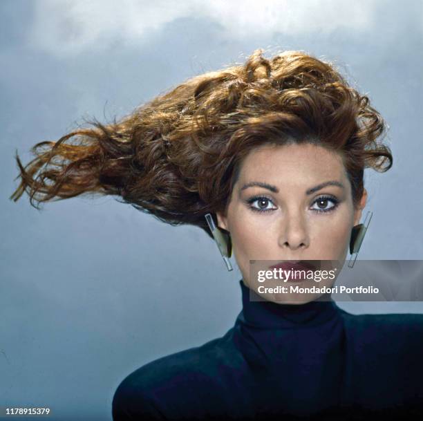 French-born Italian actress Edwige Fenech with an outlandish hairstyle. 1987